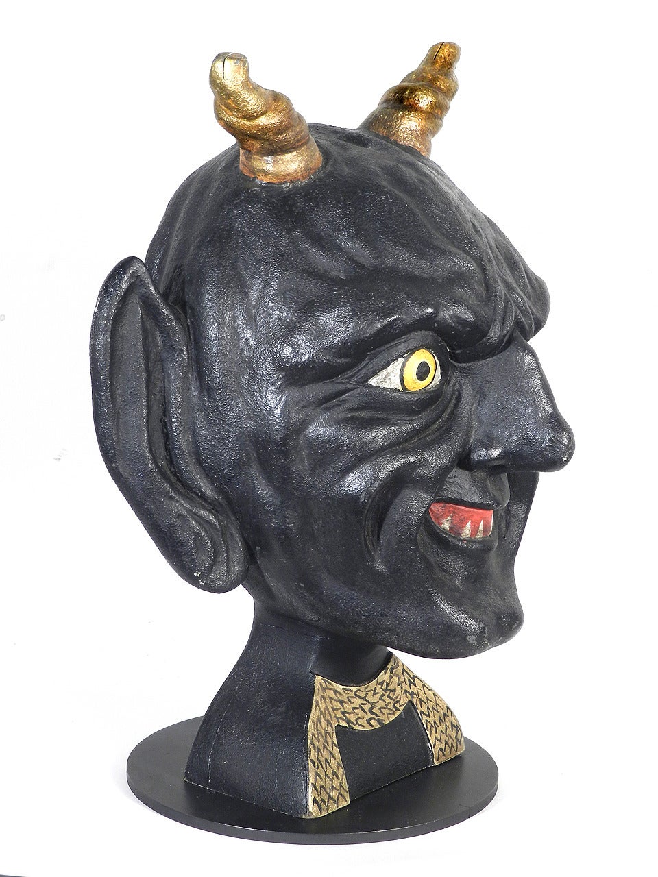 This is an amazing hand-carved one of a kind solid wood devil's head. I can't say what movie it was in or if it was just a test character. In any cast Tom Burton liked it enough to display and be photographed with it. If you look at the picture the