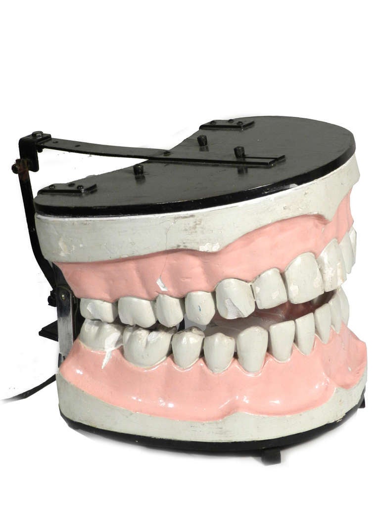 This is a large automaton that I guess was used as an advertising display.
When plugged in the teeth smoothly open and close and can go all day long. The teeth and gums are plaster with a wood frame.  The paint is original with a few chips and