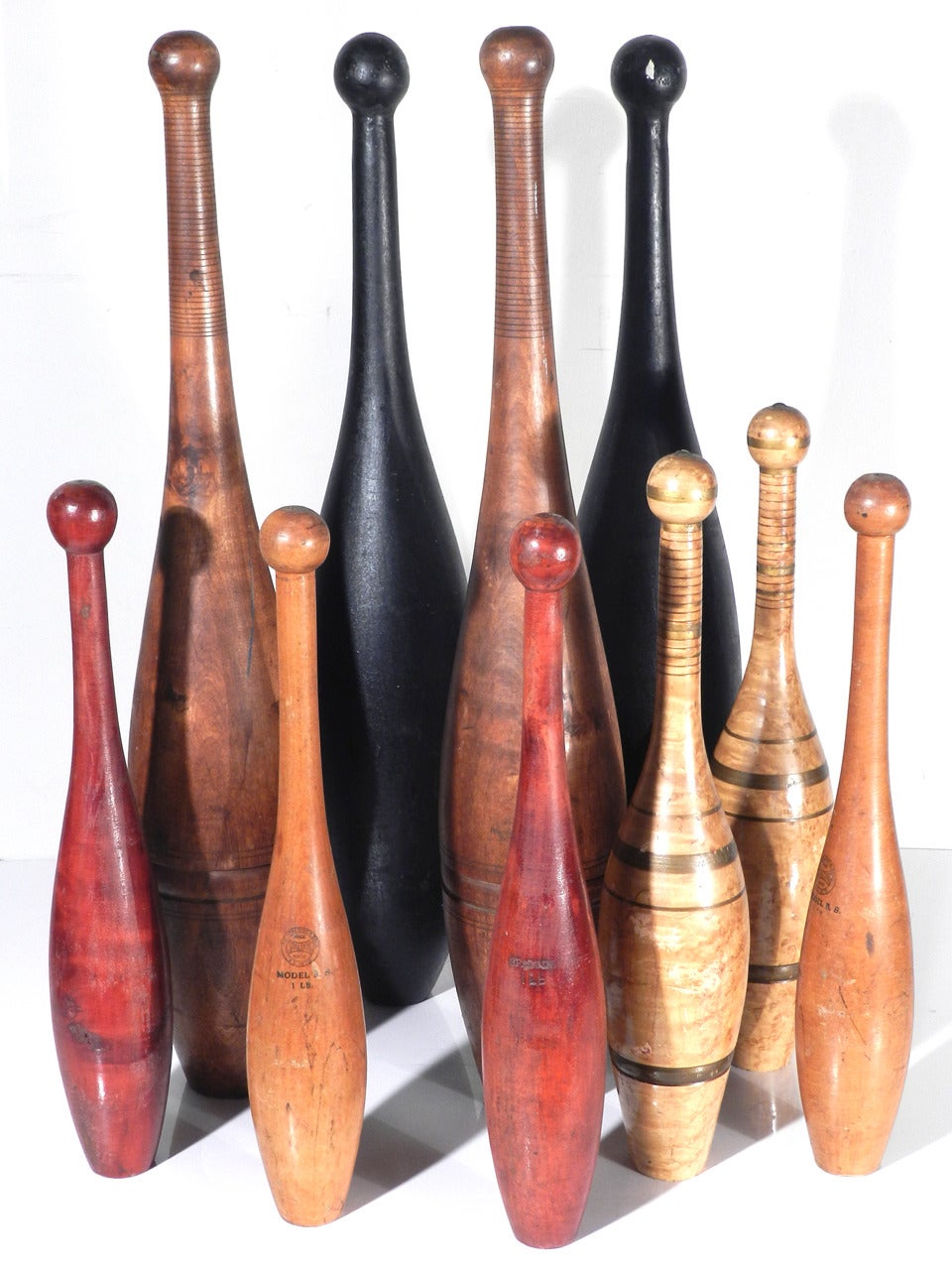 This is a wonderful collection of ten Victorian Era Indian Clubs. There are five matching pairs in excellent original paint and a beautiful patina. They range in size from over two foot to 16 inches. As a group they make an impressive
