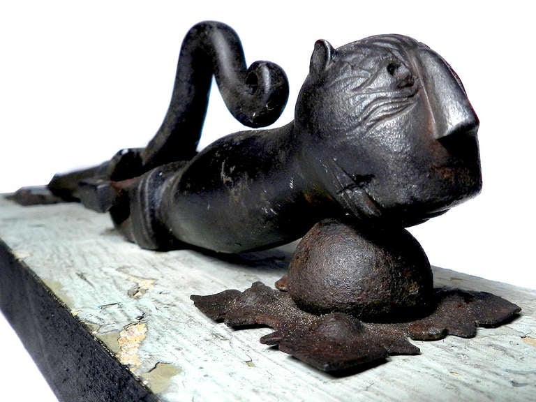 Attention Cat Lovers! This is an early blacksmith made iron door knocker. This is a wonderful one of a kind object. Its mounted to a wood panel with layers of early paint. The patina is just right. This is an amazing piece of folk art. Its well done