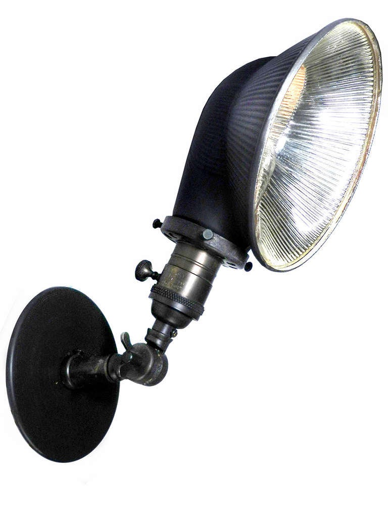 This small squat mercury glass shade is one of the most interesting shapes that they ever made. It's size and side mounted bulb make this a perfect sconce reading lamp. It can point down to light a hall or tilt up to reveal the striking ribbed