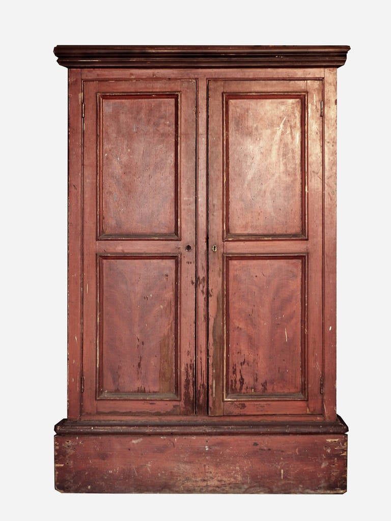 The original brick red paint and the fow painted wood grain panels make this cupboard very likable. The size is also very useable, Its only 11 inches deep and make a perfect backdrop for any room.
