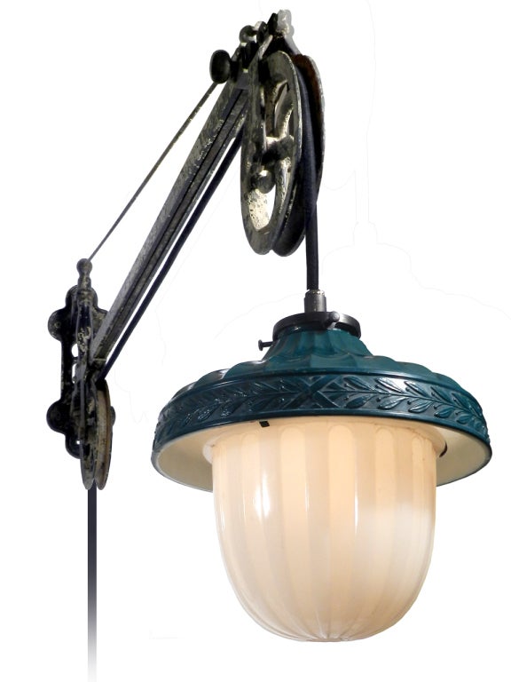 These lamps are very hard to come by and this example is an untouched original. All we did was rewire it with the correct reproduction fabric covered pulley wire. The wall bracket has a great original patina. It swings left to right and can extend