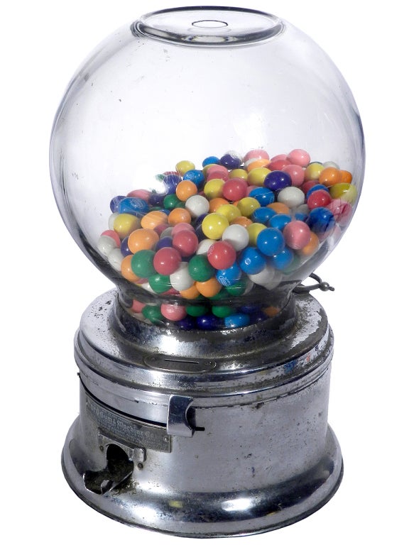 This is the quintessential early gum ball machine. It stands 11.5 inches tall with a 7 inch diameter. The finish has some age and shows a worn patina.  Put a penny in the slot and the mechanism works perfectly. It could be a whole new business for