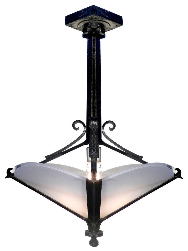 This is a very elegant and simple pair of Art Deco lamps. The iron frame, stem and canopy are one piece. The metal parts have a light textured finish cut into the surface. I don't want to call it bamboo but it has that feel. The four glass plates