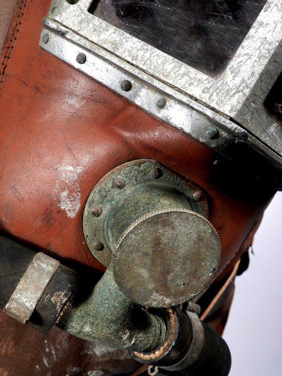 This is an early fireman's smoke mask. These full face helmets are very rare and found mostly in museum collections. This example is unsigned. The front windows use Mica to see through. The window frame is aluminum. This is also one go the first