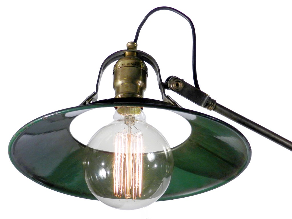 This is a nice clean Bauhaus style articulated desk lamp. The green porcelain halo shade is a design feature we have not yet seen and we love it. The shade is 9.5 inches in diameter and simply snaps into a clip to hold it. With the big round Edison