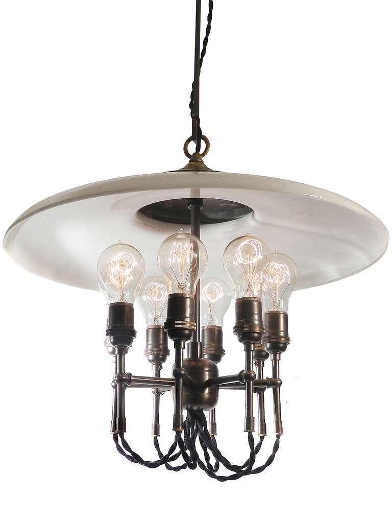 With an impressive diameter over 20 inches his early milk glass shade is as large as they come.  The lamp is also 20 inches tall and uses 8 edison bulbs.