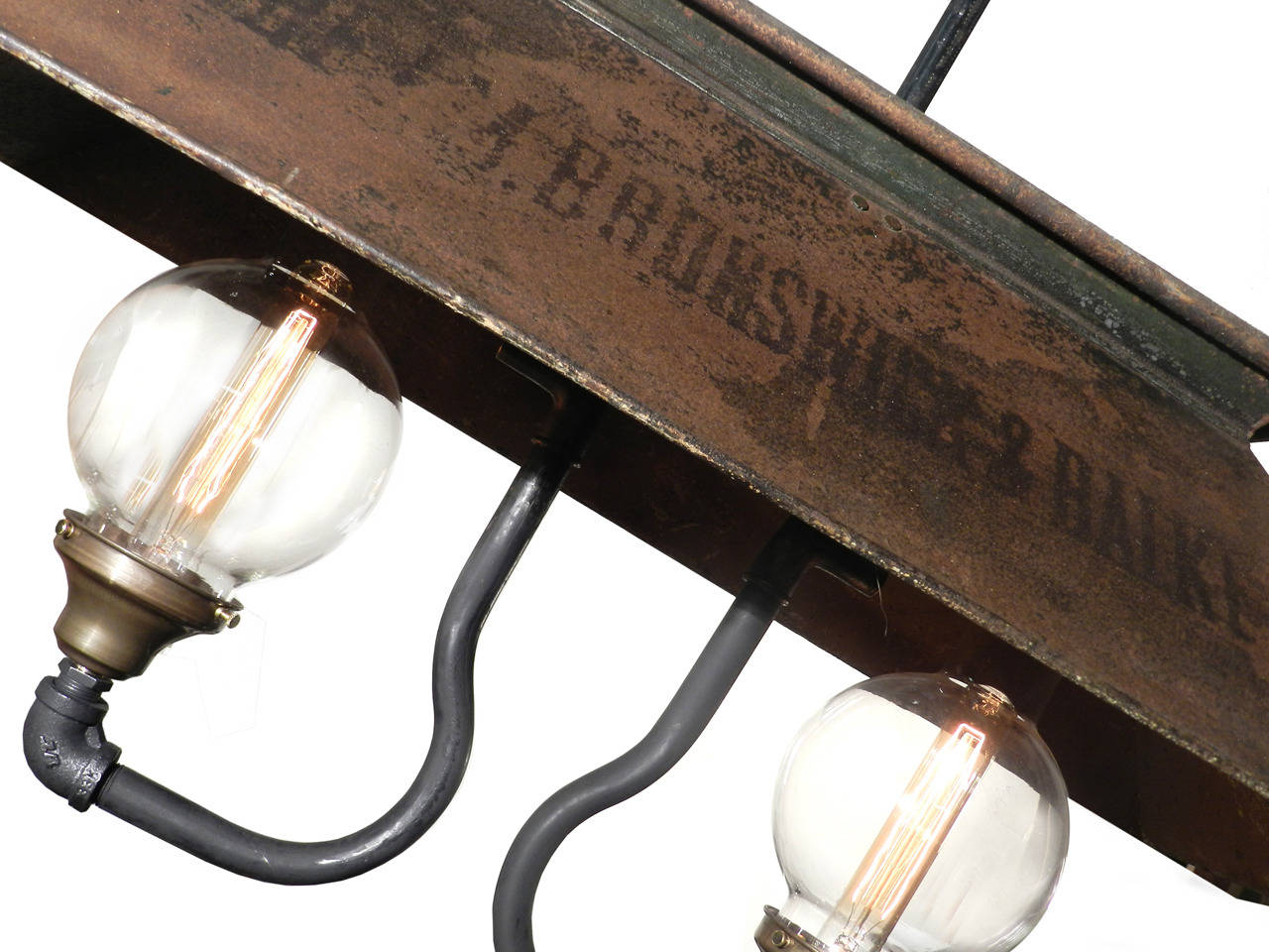 The tin shade on this lamp is a real survivor. It still has the original lettering advertising the maker J. M. Brunswick And Blake Co. This dates it to the early 1880s. It's been electrified for everyday use but originally used kerosene to fuel it.