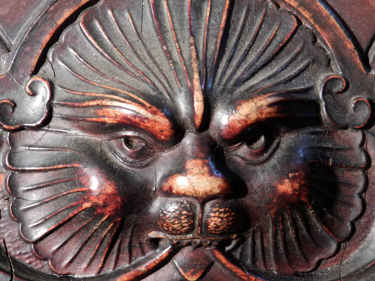 This is a wonderful cabinet that's loaded with character. The woods have a nice bright color with tons of carved detail. There are three bevelled mirror panels and display shelves all around. The two center panels pull-out as racks to store sheet