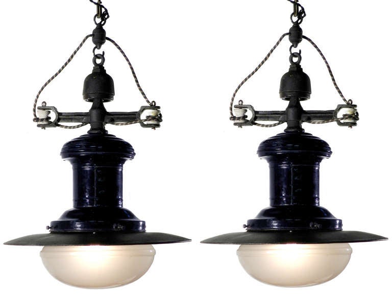 This is a matching and is being sold that way. The lamps are very unique with large pancake frosted glass globes. The 20 inch shade has a black pebbled finish over white porcelain. The body also has a porcelain finish in blue. The top dog bone wire