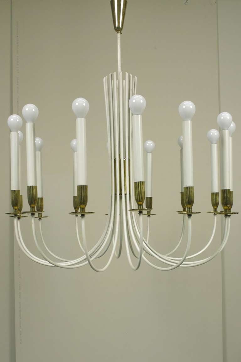 A pair of fourteen-light light chandeliers of enameled metal and brass.