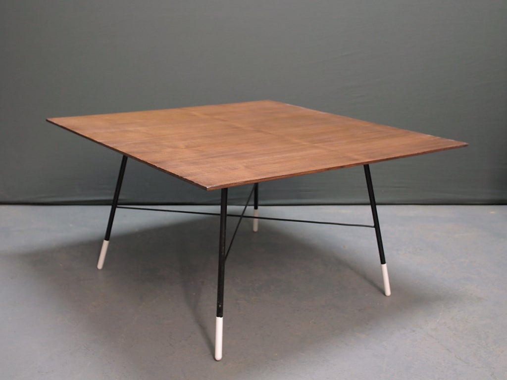 Veneered walnut top on metal base with white painted feet.