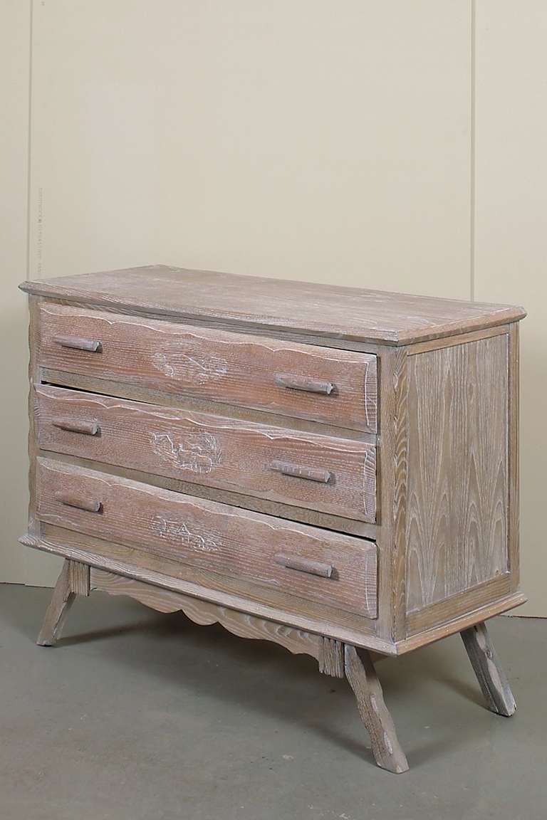 A carved and cerused oak chest of drawers.