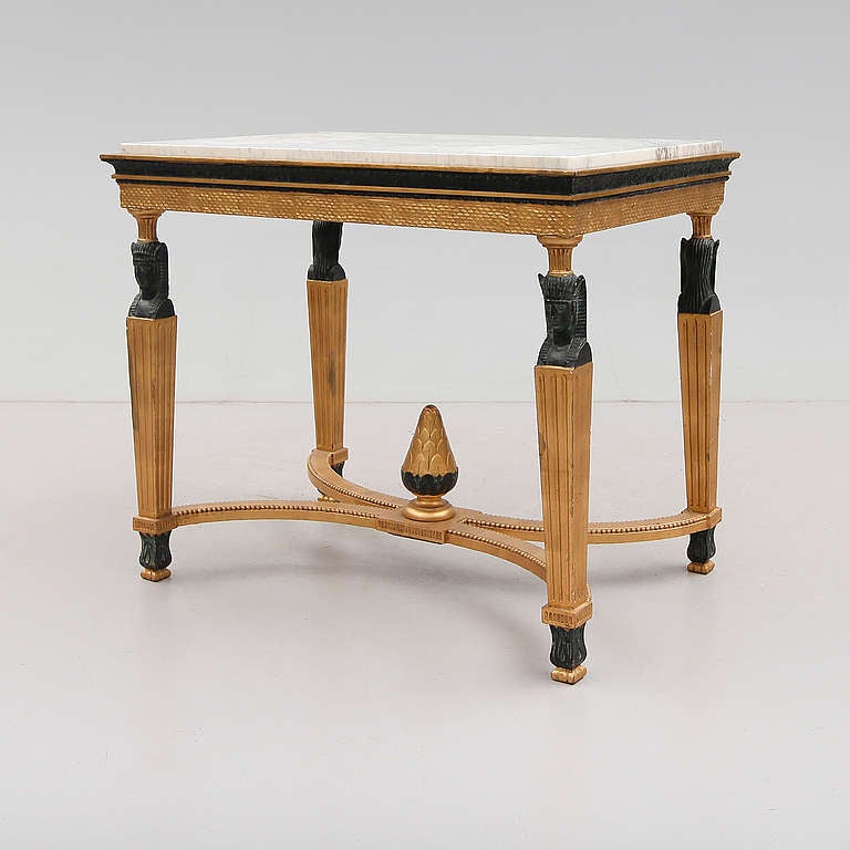 The marble top resting on four Egyptian style columns.