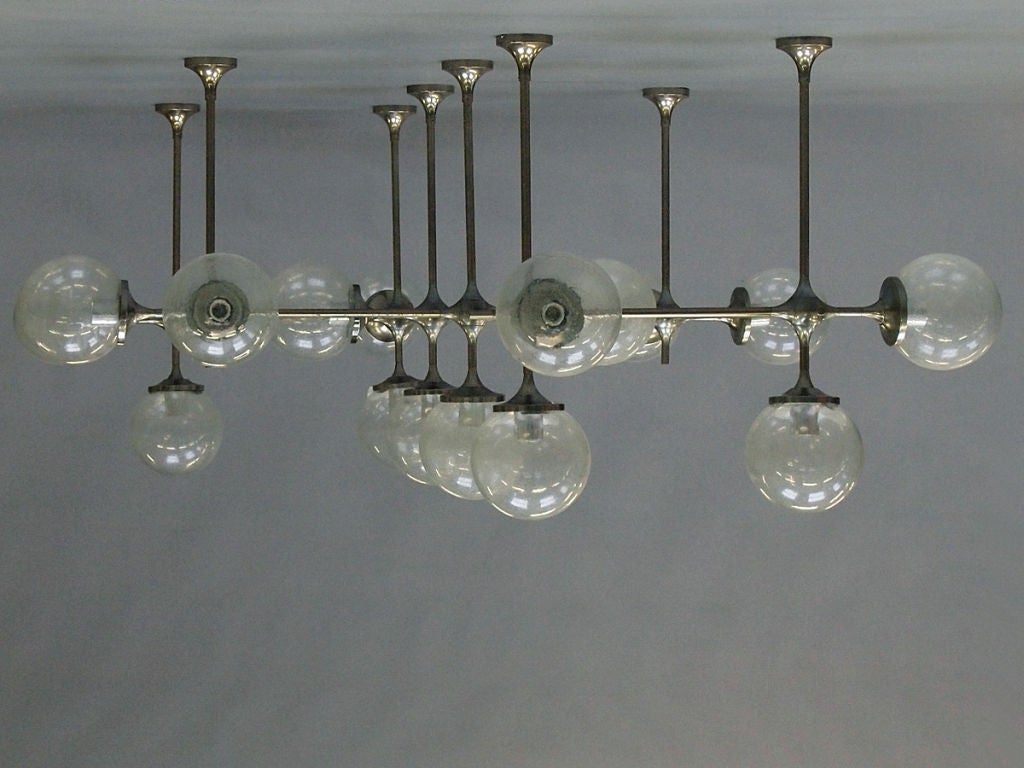 A Module I light fixture by Peter Rockel. The polished steel structure with spherical glass shades.

Provenance: From the former Palace of the Republic, East Berlin.