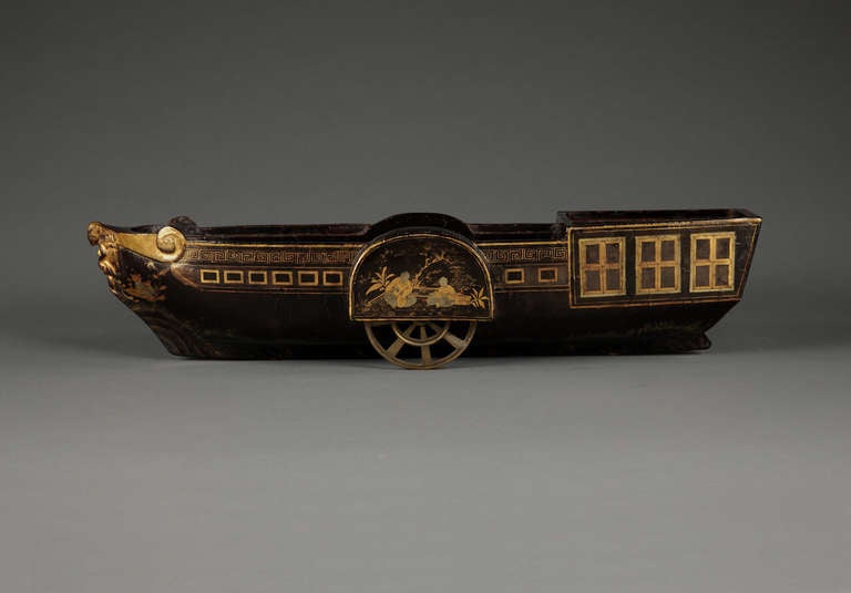 Of black lacquer, gilt-brass and two-color gilding. The hull edged with gilt Chinese meander pattern above a series of gilt framed rectangular 