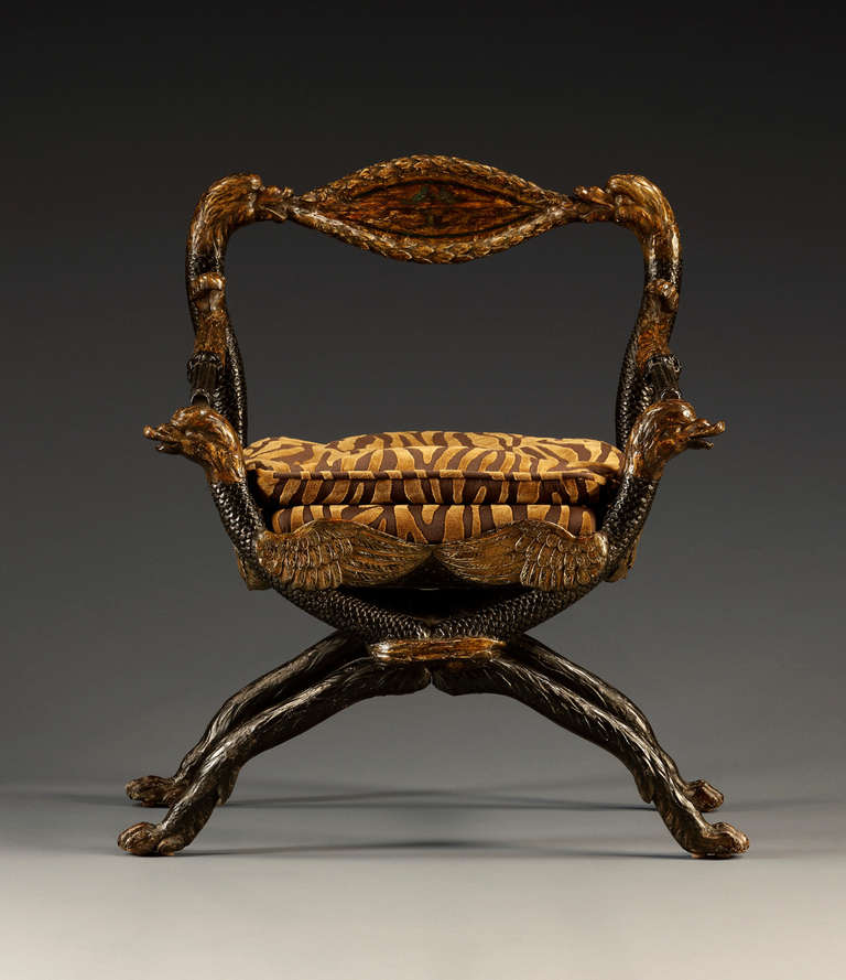 Each retaining original gilt and ebonized decoration. The chairs surmounted by elongated oval splats with laurel carved edges enclosing a vignette of two facing birds. The back uprights formed of two facing serpents from which issue acanthine and