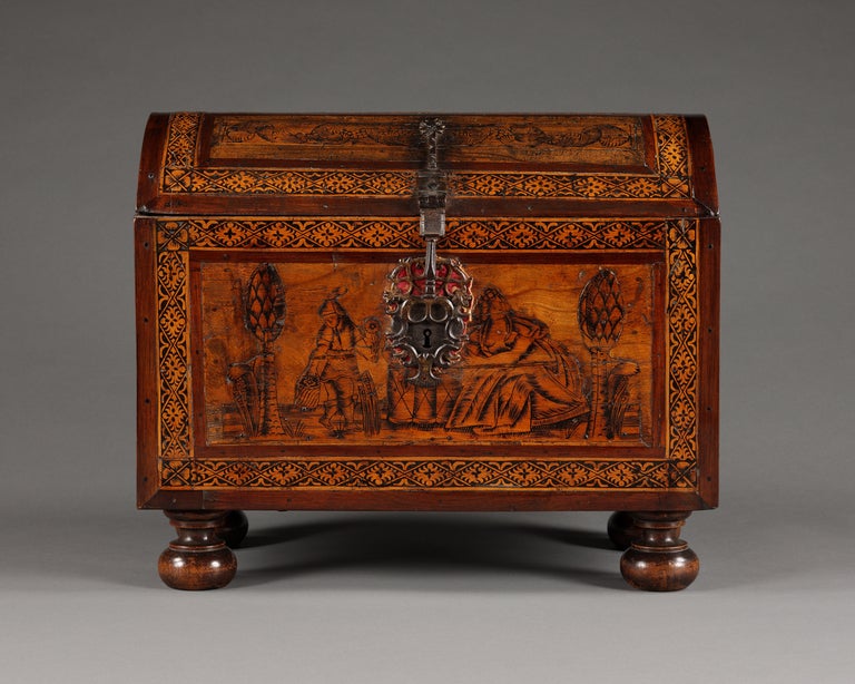 Of rectangular form, decorated on four sides with marquetry and zumaque -filled engraving. The front depicting Flora's garden, the sides depicting harvesting scenes, and the back depicting a deer hunt. The perimeter of each side decorated with a