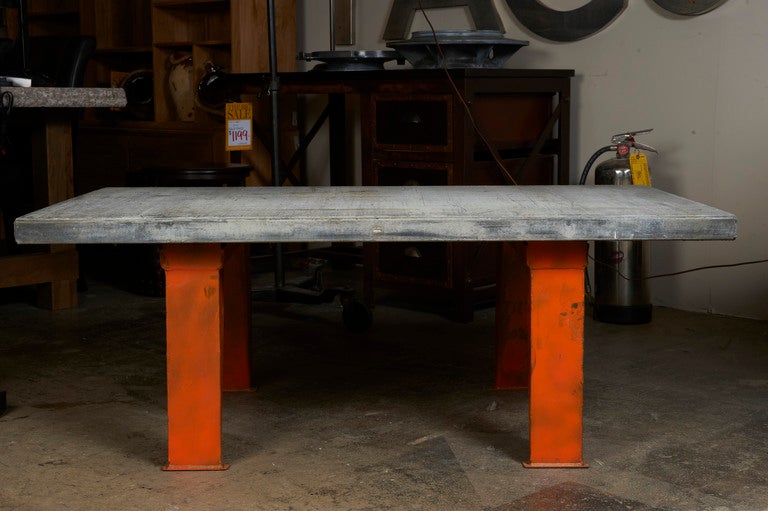 Industrial base/pallet top table, c. 1950 with orange painted iron legged base, and mason's pallet work top.