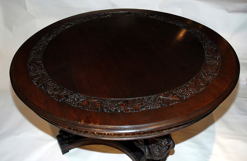 A massive carved oak center table, consisting of 4 winged<br />
griffins around a carved standard,supporting a 54