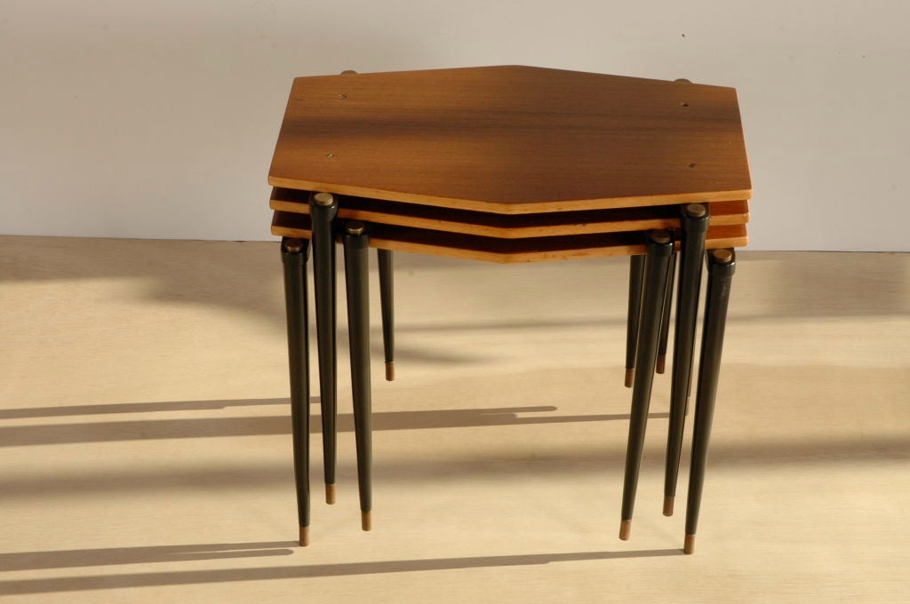 Set of three interlocking teak tables, black lacquered wooden legs, brass feet and caps.
Produced by SAF (Scandinavian Authentic Furniture).