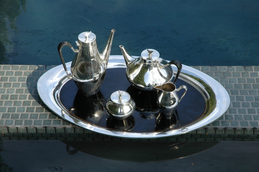 Very beautiful silver plate tea and coffee service designed by John Prip for Reed & Barton in 1958. 

Set is presented on the original optional black lacquer wood insert.The handles on the tea and coffee retain their original woven black