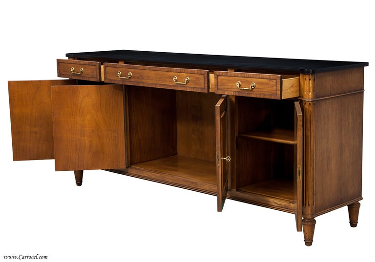 Here is a lovely cherry wood credenza made by OLD COLONY FURNITURE.  It can be used as a sideboard or buffet but perhaps is best suited as an entertainment storage cabinet due to its unique height.  This piece is right at home sitting under a sleek