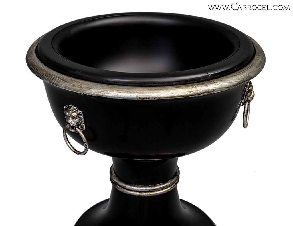 This is a newly made piece that has been custom finished in a satin black lacquer with distressed hand-applied silver leaf accenting.  It has a metal tray inside the bowl allowing it to be used as a planter or as a wine cooler.  Exquisitely finished