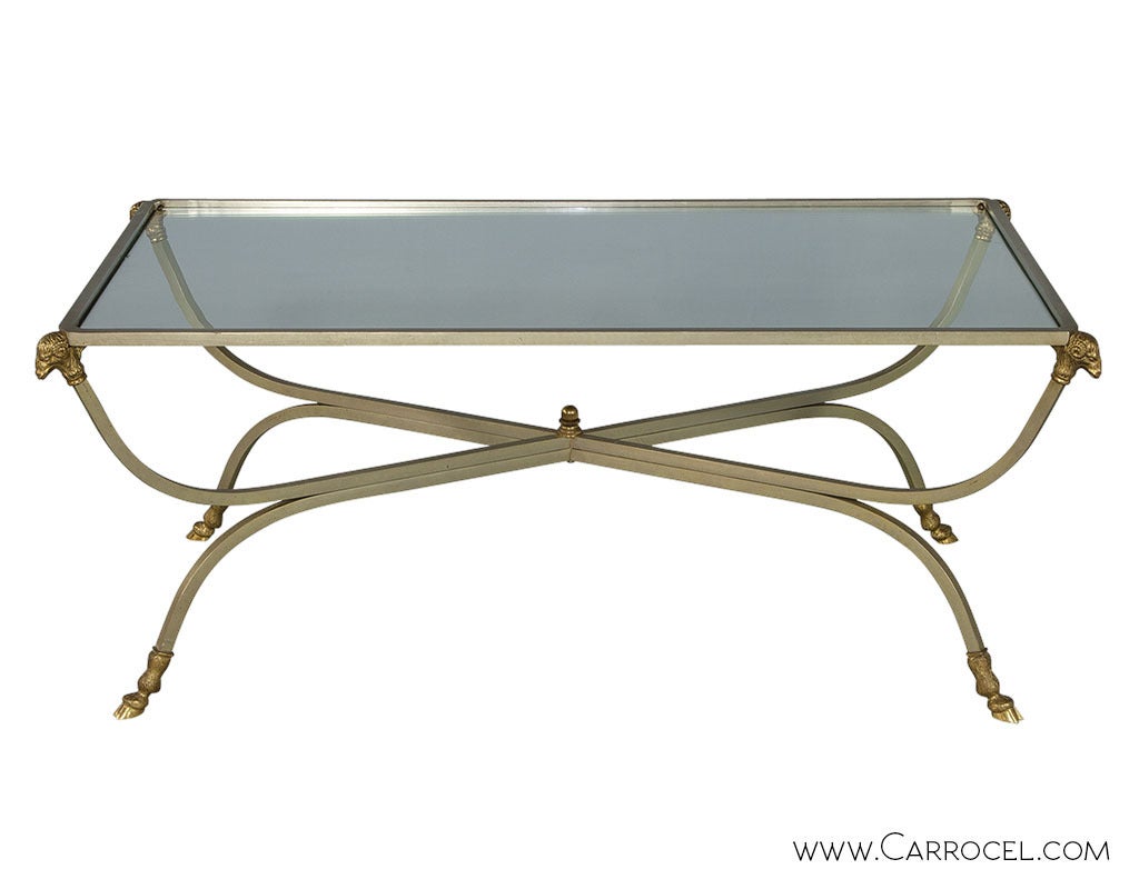 Brushed steel frame accented with brass ram’s heads and a hoof on each foot. Attributed to Maison Jansen.