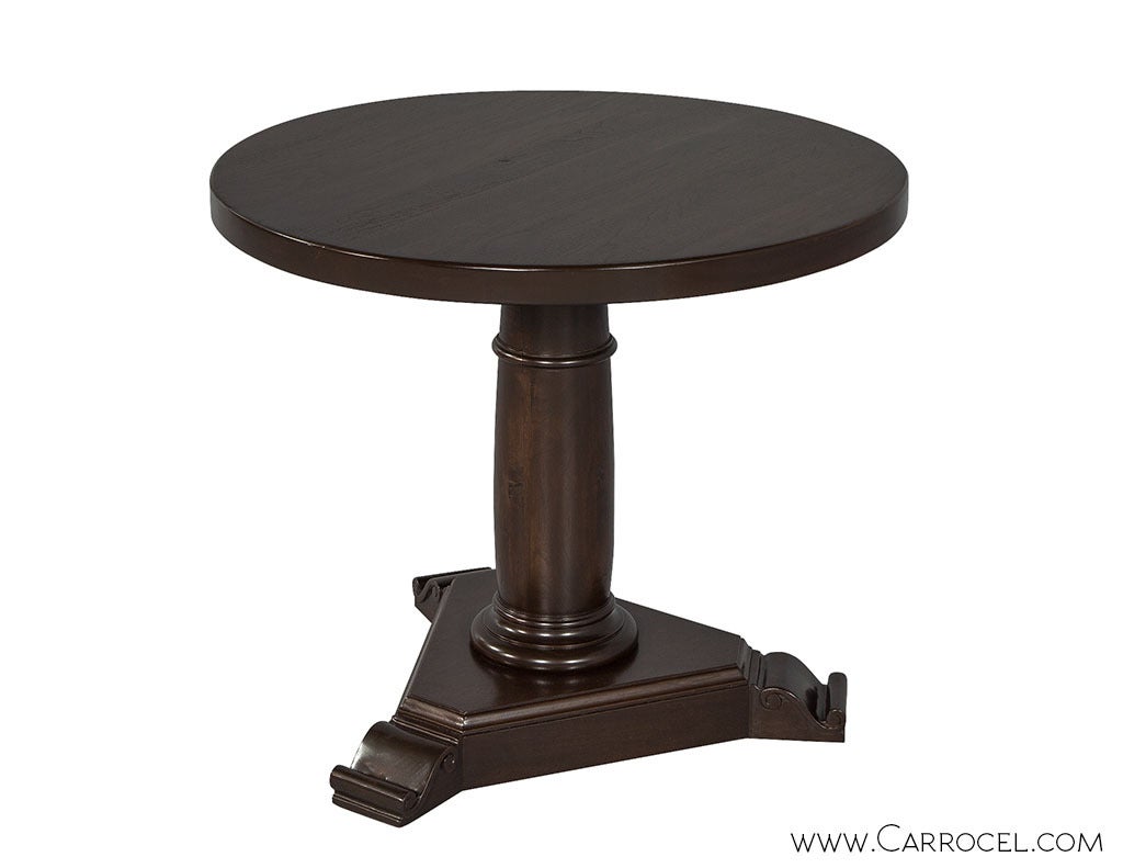 American Empire style centre table on a turned pedestal base finished in dark walnut.