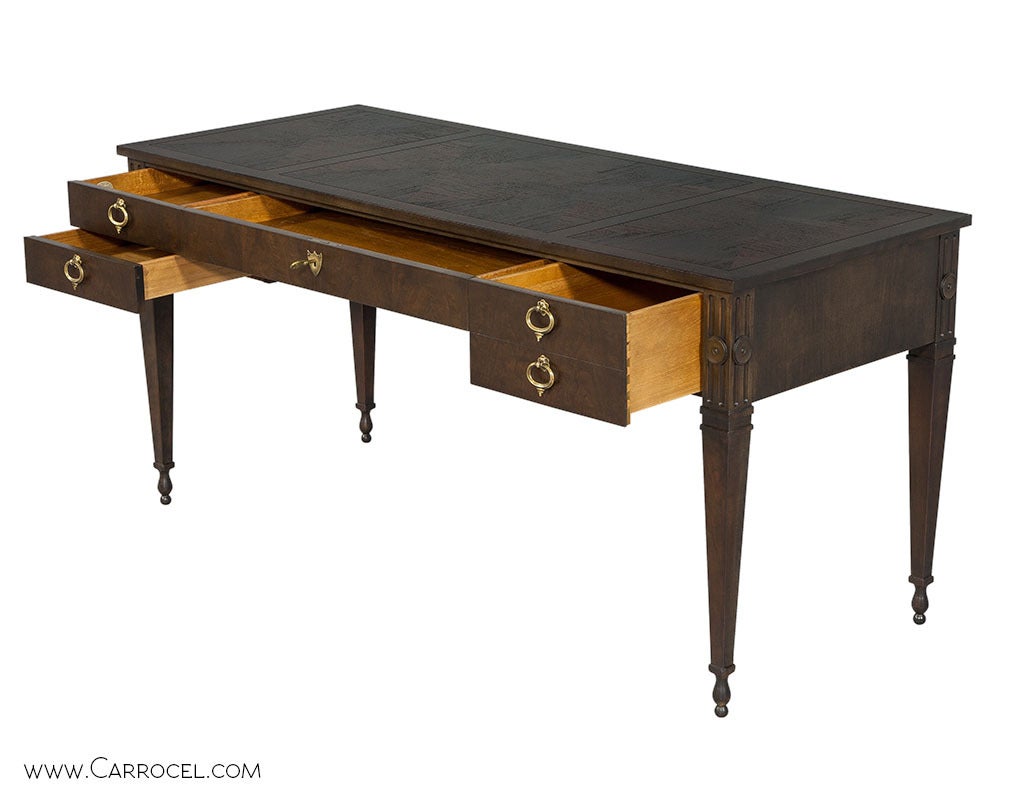 Gorgeous and finely crafted Louis XVI style desk from the American manufacture, Baker Furniture. The desk has the original hardware and features an x-pattern veneer motif across the top. Recently Refinished in 2015 by Carrocel to a rich walnut tone.