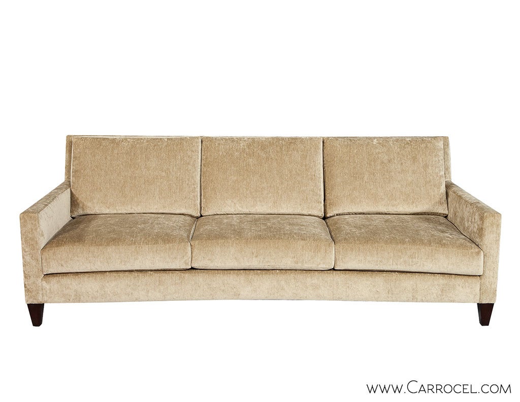 The Baker Furniture Mason Sofa offers modern clean lines, with narrow track arms and a slight concave curvature along the face of the sofa. Raised on dark espresso tapered legs, with three Baker comfort cushion seats, this sofa appears modern while