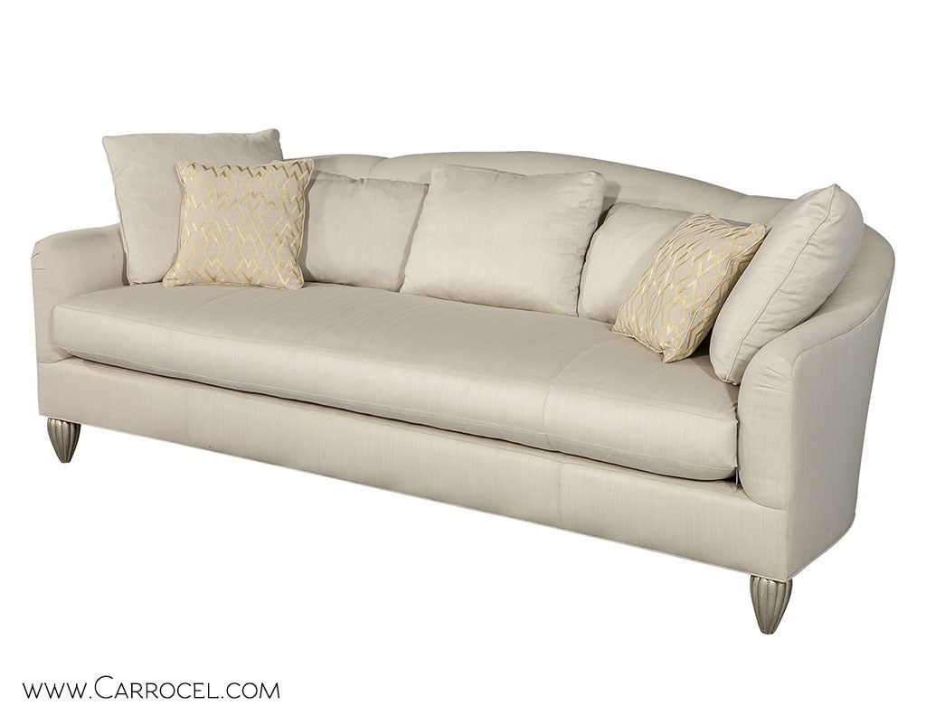 The Barbara Barry Collection for Baker Furniture Soiree Sofa. Luxurious to sit on with voluminous down blend cushion. The sofa is raised on melon-shaped carved wood feet, finished in antiqued silver leaf.