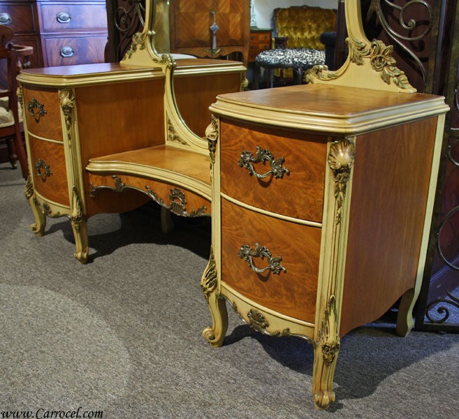 This is a beautiful French Provincial bedroom vanity desk made from solid cherry with solid brass hardware and exquisite intricate hand-carvings. It is made in the United States around the 1950s styled after the much-sought after French Provincial