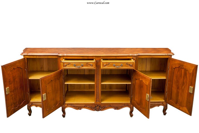 Here we have a fantastic French Provincial sideboard that was imported from France.  It is a vintage piece and is exceedingly well with cherry solids, a gorgeous parquet top, dovetail drawer construction, and solid brass hardware.  It is the perfect