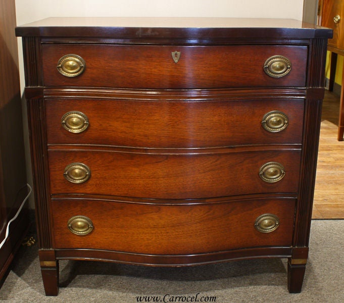 This is a solid mahogany chest of drawers made in America in the 1930s or 1940s. It is in its original condition, which shows off the piece's beautiful rich patina that only a lifetime of care and light polishing can bring. It also features solid