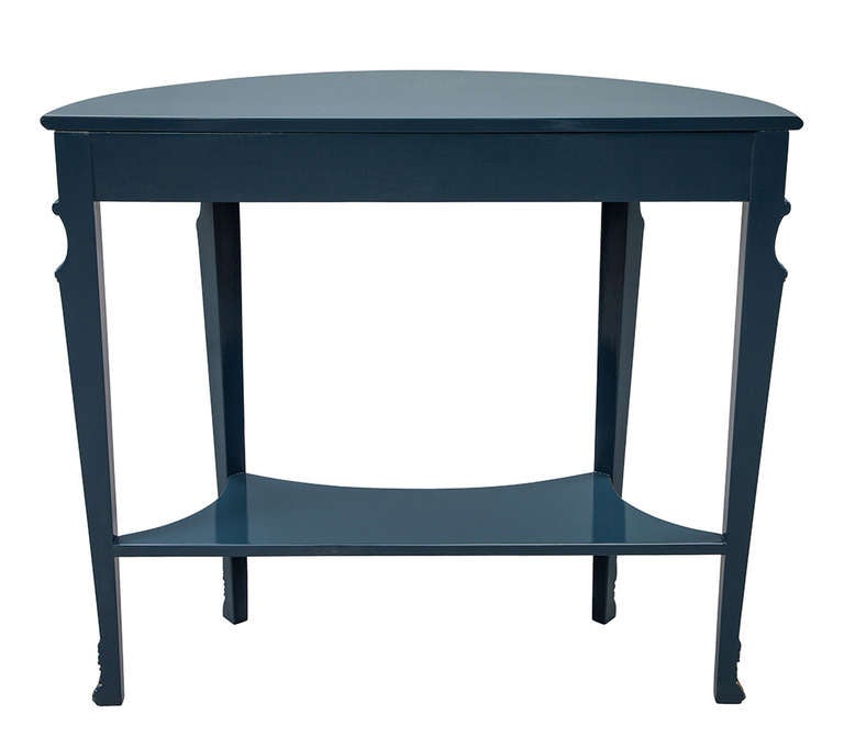 Stunning French Regency style demi-Lune console table. This Circa 1940’s American made table was recently restored in a hand polished Gulf Blue lacquer with gold leaf painted accents and hand carved floral motifs. Perfect for a hallway, foyer,