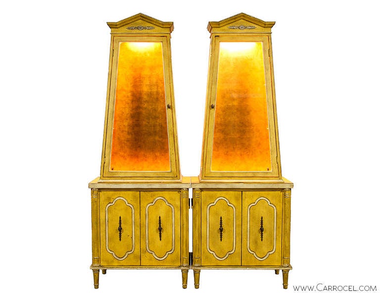 These uniquely shaped armoire cabinets would be a perfect impact piece for any room. If you need that added punch of color or uniqueness look no further. Featuring a distressed yellow patina and gold leaf backing, the combination is truly rare. This