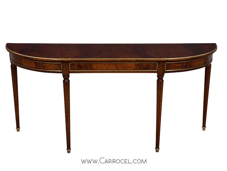 Unique Flamed (Crotch) mahogany hall console table in original excellent condition. Graceful and elegant this table is a classic and timeless design, with rich flame mahogany masterfully matched, smooth flowing curved top and original brass trim