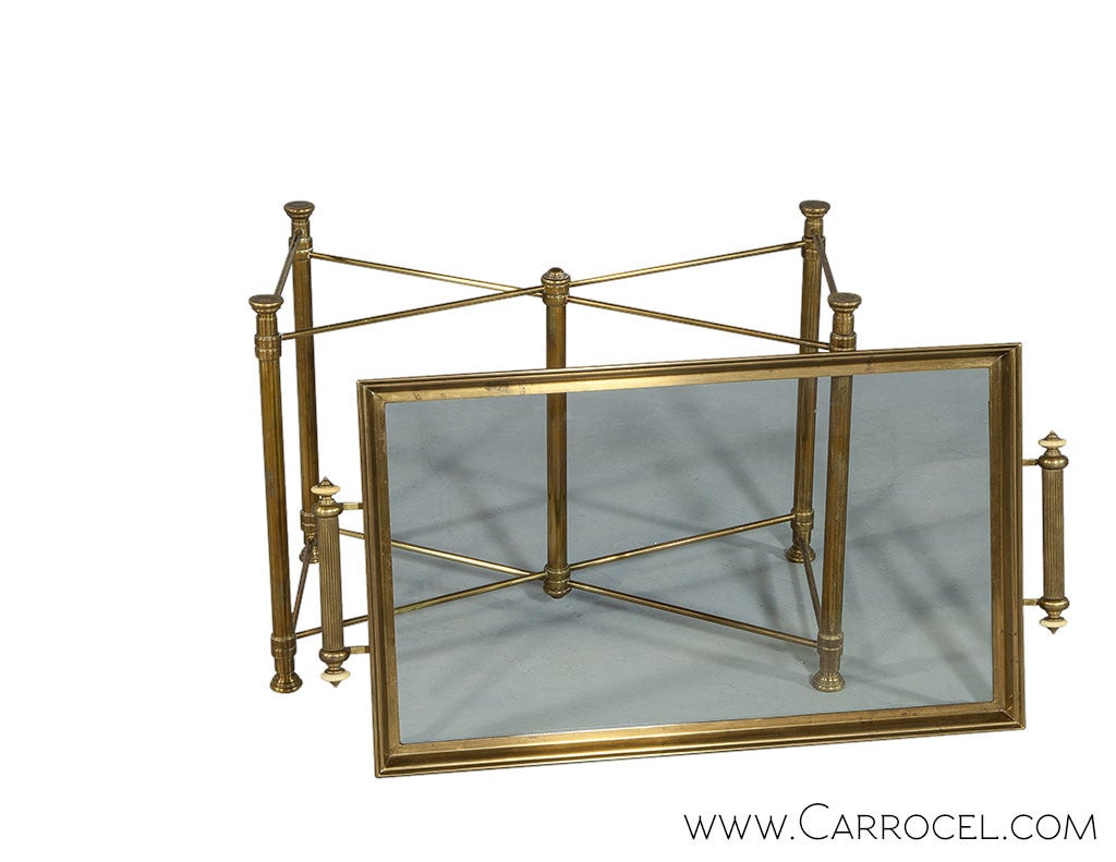 A Mid Century brass edge tray with fluted handles, mounted as a coffee table on a brass x-base stand.