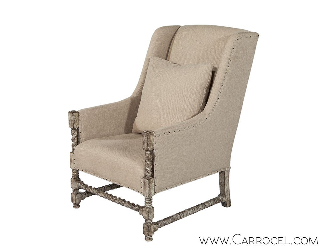 Rustic custom distressed finish lounge chair. The unique Barley twisted frame is upholstered in a relaxed linen fabric, trimmed with upholstery tacks and comes with a luxurious down filled throw cushion. These chairs can be custom ordered in