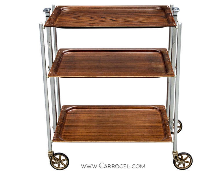 Vintage Mid Century folding tea bar trolley cart, chrome frame with laminated shelves. Made in France roughly 1960 in excellent condition. Click in top two buttons to release and fold, working great and in perfect original condition.