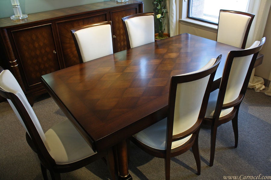 This is antique Art Deco style dining set made in France in the 1940s.  It is made from walnut and cherry wood with beautiful parquet and sunburst patterns.  The entire set has been completely professionally restored by our master artisans.  The