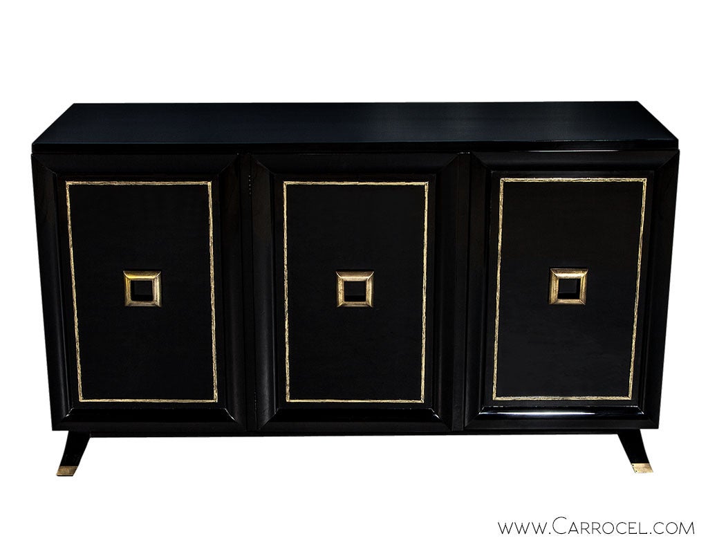 Vintage Mid Century Modern Piano black lacquer finish, hand polished credenza console buffet. Absolutely stunning and timeless this classic sideboard buffet is simple and elegant. The raised gold leafed door motifs and oversized square original