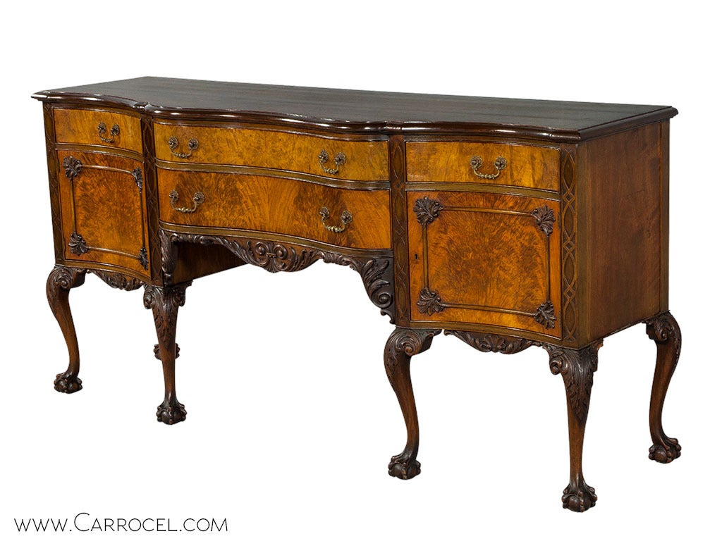 Antique 19th Century Chippendale Ball and Claw sideboard. This sideboard is a classic example of superior craftsmanship combined with traditional design. Hand carved walnut and beautifully matched rare feathered walnut veneers adorn this