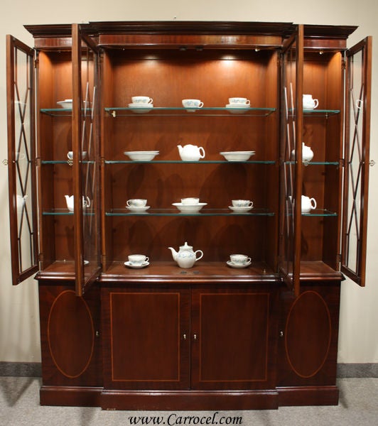 This is an beautiful mahogany china cabinet made by Baker Furniture in the mid-20th century.  Of course, Baker Furniture is a hallmark of the fine furniture industry and have been known to this day for the manufacturing of the highest quality case