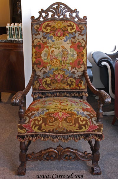 ere we have a late 19th century solid walnut hand-carved Gothic-styled arm chair.  It is in its original condition with its hand-woven needlepoint upholstery and is in great condition without any significant scratches or blemishes.  Its age has