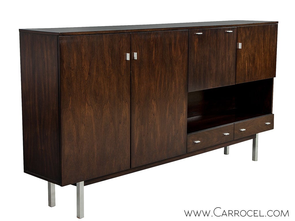 Sample the classic mid-century interplay of wood and metal, overlaid with a modern approach to storage organization. This credenza built in exquisite rosewood and restored by Carrocel craftsmen in our custom Toasted Brazilian Nut finish. With