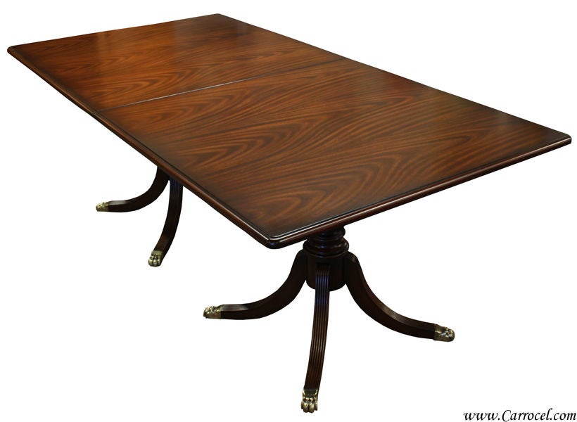 This is a beautiful mahogany classic Duncan Phyfe styled dining table.  It is newly made and brand new.  It can also be custom finished to your desired colour.  It features a pair of solid beechwood Italian-made 4-legged pedestal with lion's paw